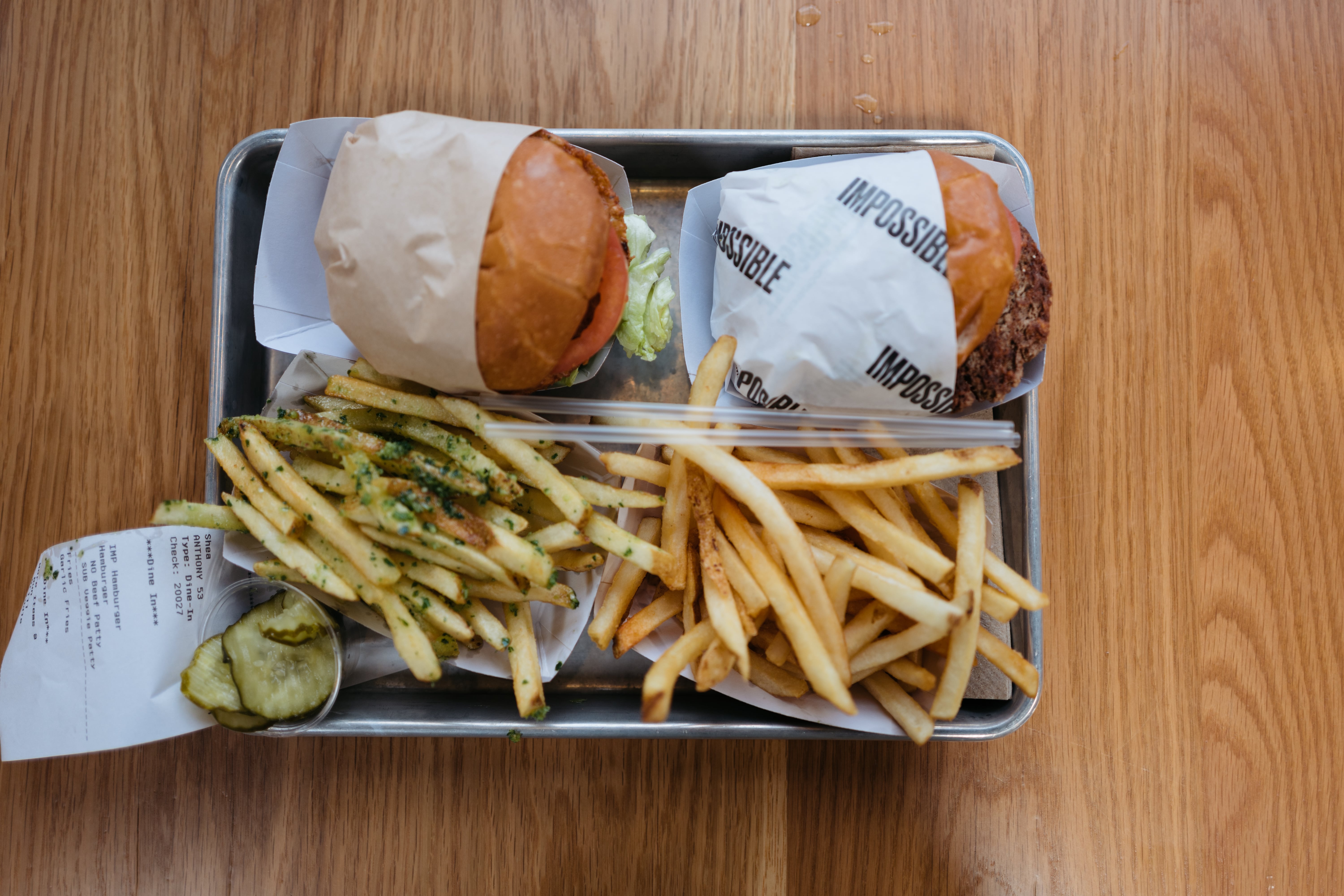 Image of Allison's and my burgers for lunch Allison's veggieburger on the left with garlic fries š, and my Impossible Burger on the right with normal fries